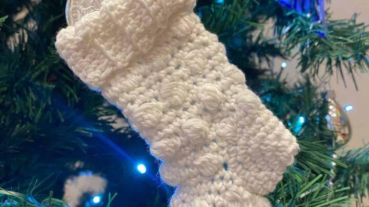 Mini crocheted chocolate stocking hanging on a tree