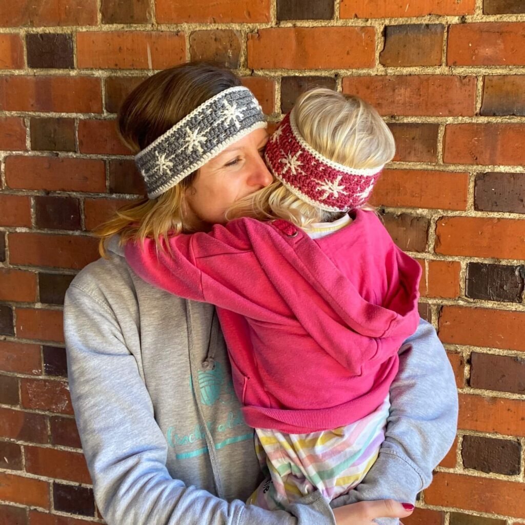 Mum and child hugging and wearing crocheted headbands