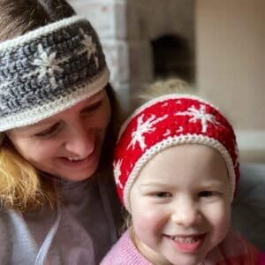 Mum and daughter wearing reversible crochet snowflake headband