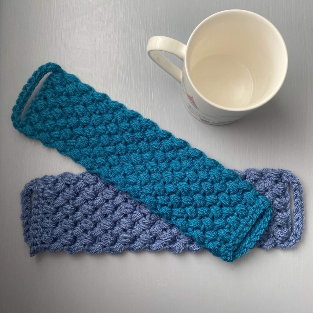 2 mug cosies next to a mug