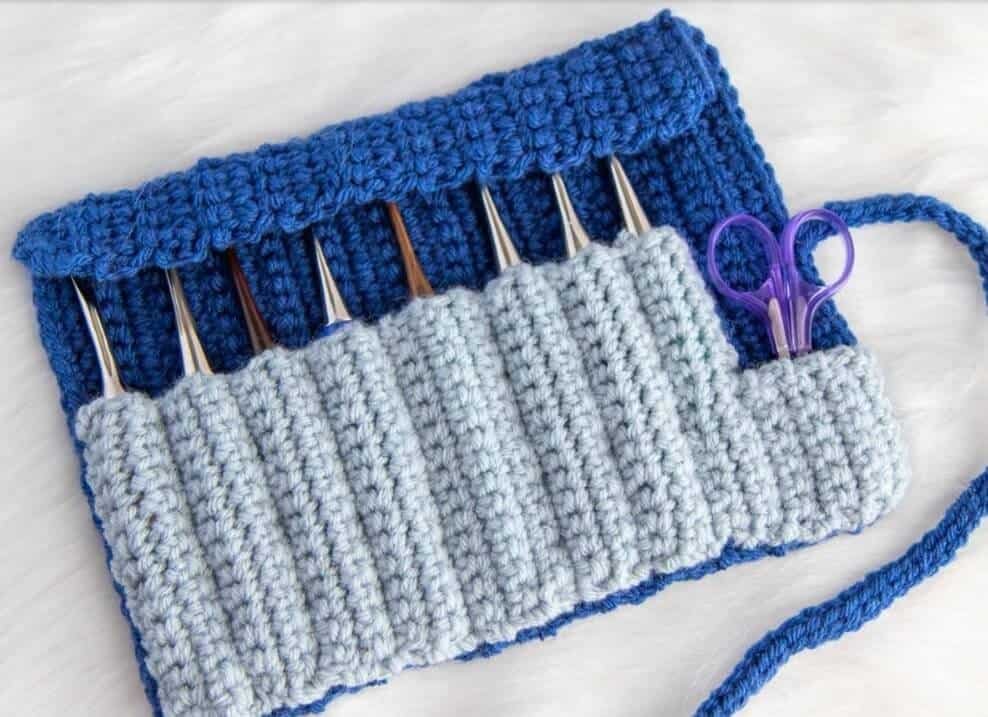 Blue crochet hook roll holding hooks and scissors