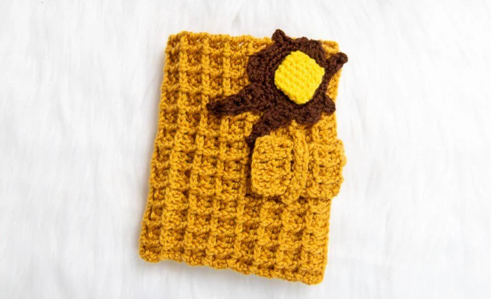 crochet hook holder that looks like a waffle with syrup and butter on