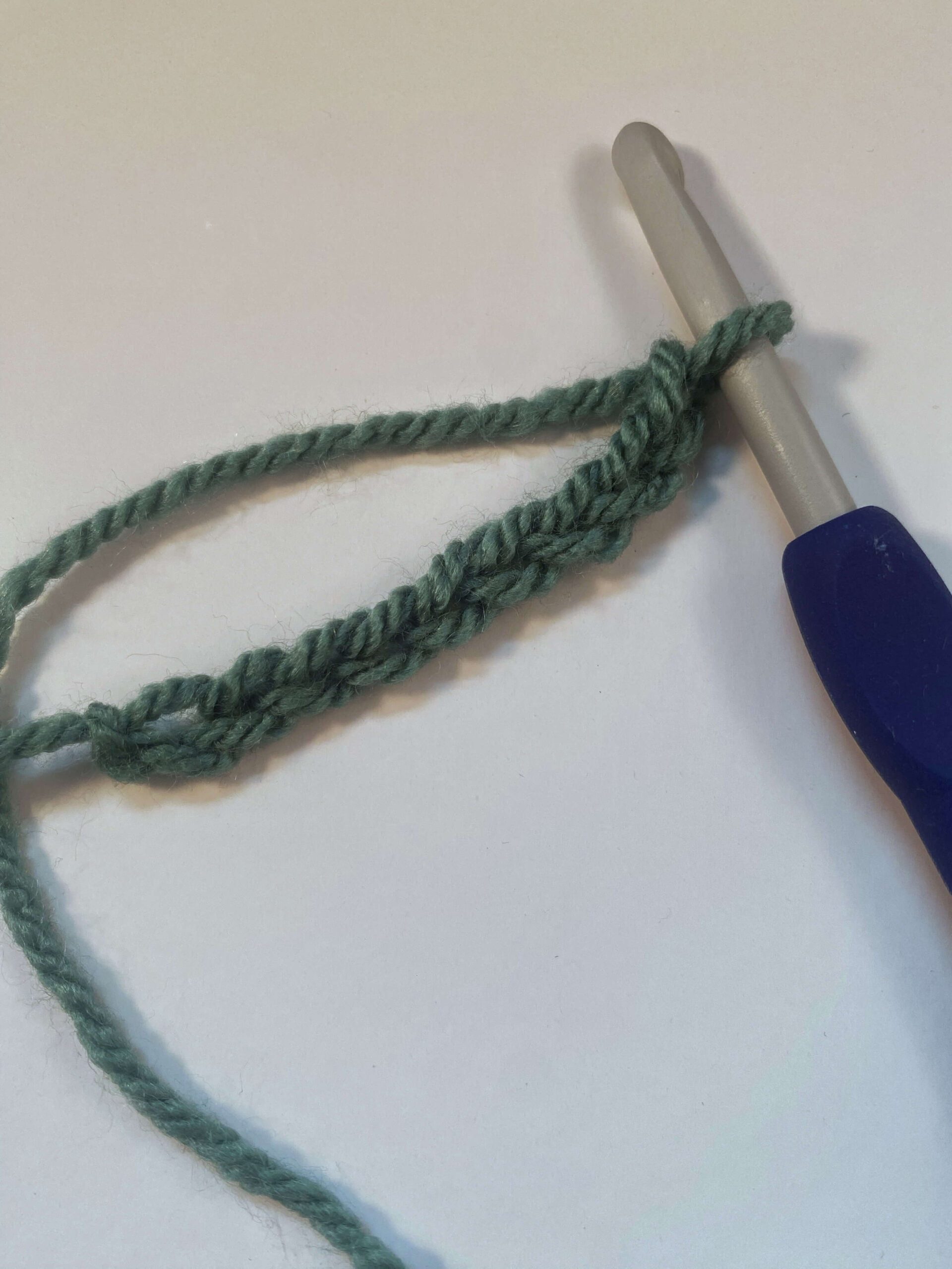 A row of crochet chain stitches on a crochet hook