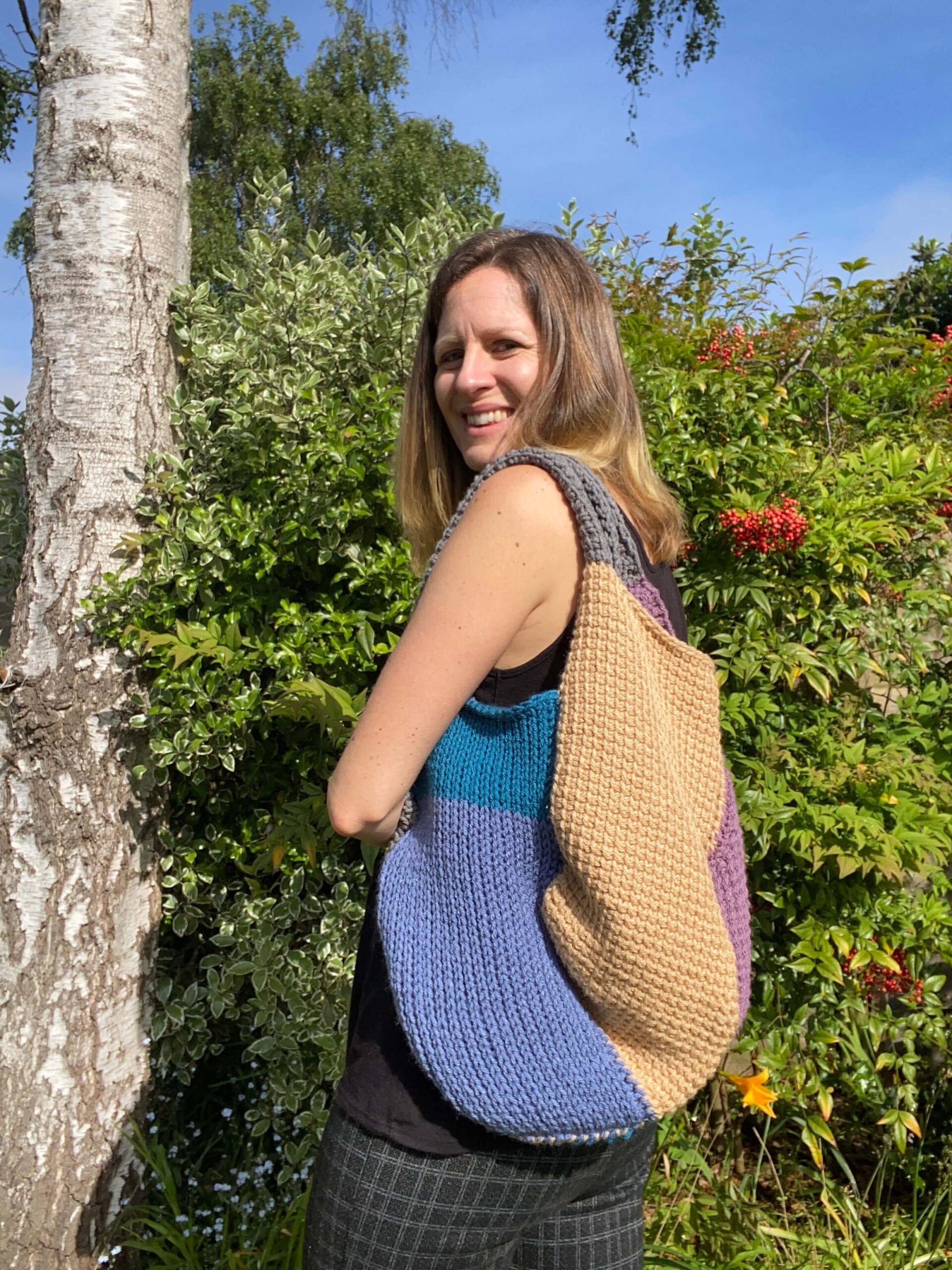 A lady carrying a patchwork bag made of Tunisian Crochet