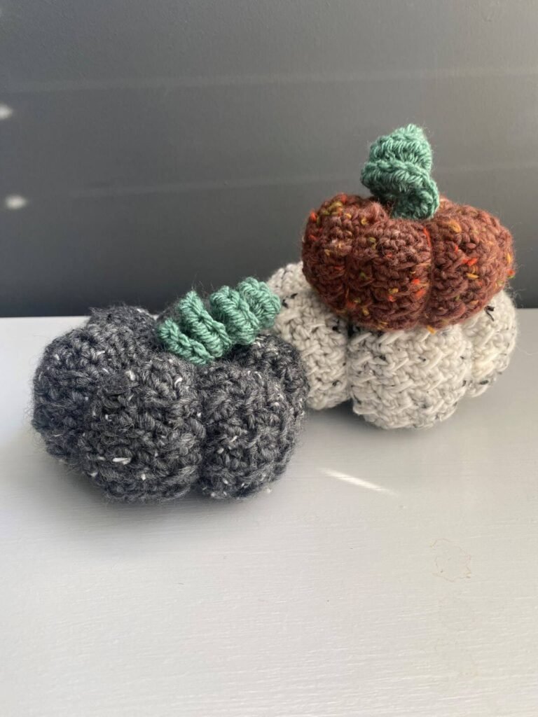 3 crochet tweed pumpkins in grey, white and red yarn