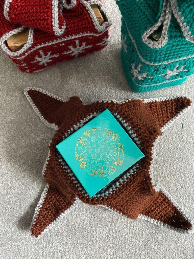 crochet gift wrap open to reveal gift inside