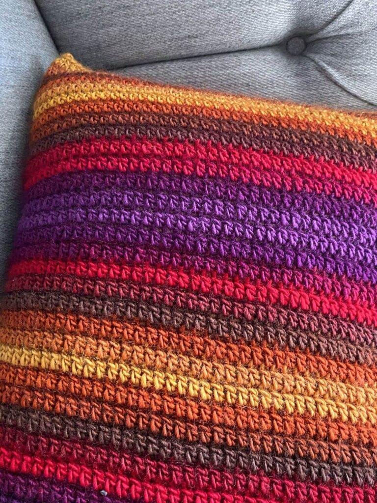 The back of the global pathways crochet cushion in bright colours