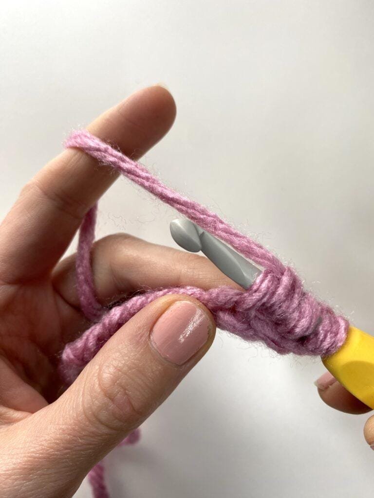 a close up of the process of making the crochet bean stitch