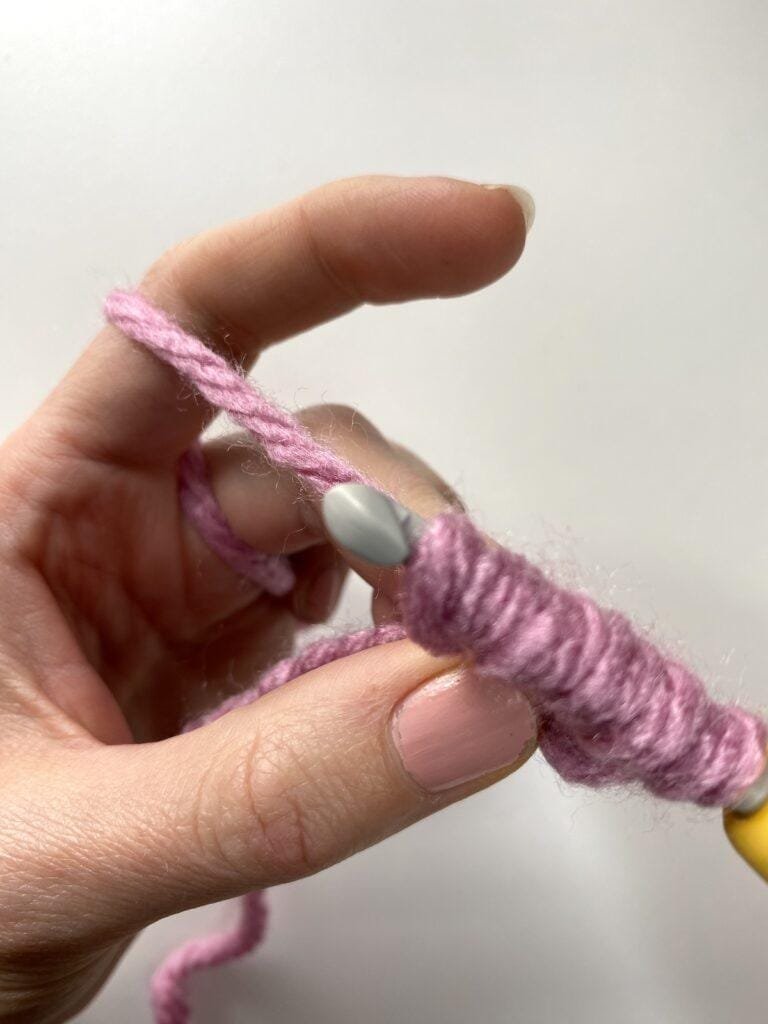 a crochet hook making the bean stitch with 6 loops on the hook