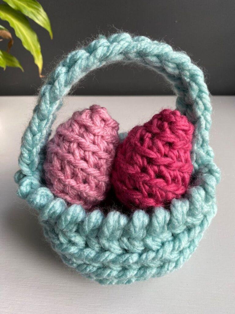 2 pink crochet eggs in a blue crochet woven Easter Basket