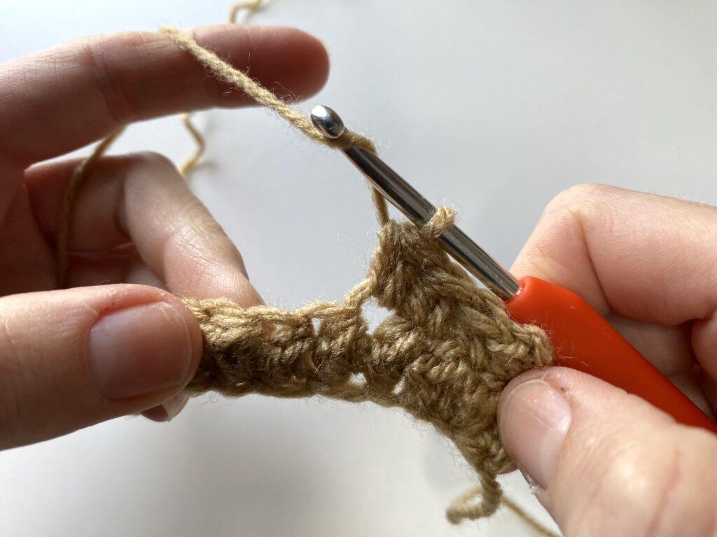 close up on the first step of the crochet pique stitch