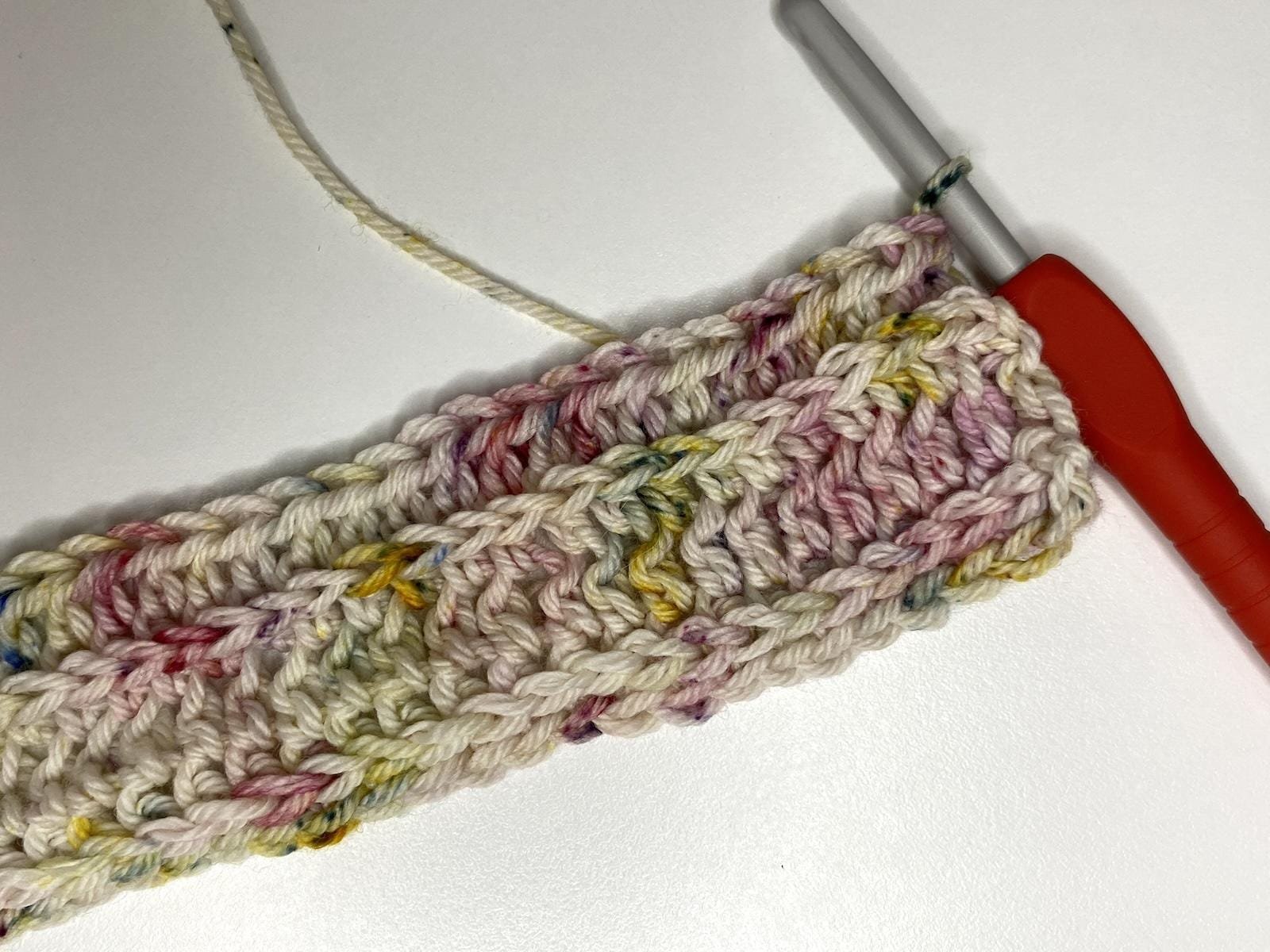 A crochet sample and hook of half double crochet in the third loop