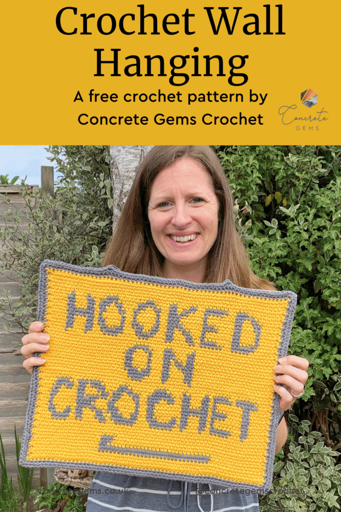 A yellow pin image for a crochet wall hanging features a woman holding the wallhanging up whilst standing in a garden