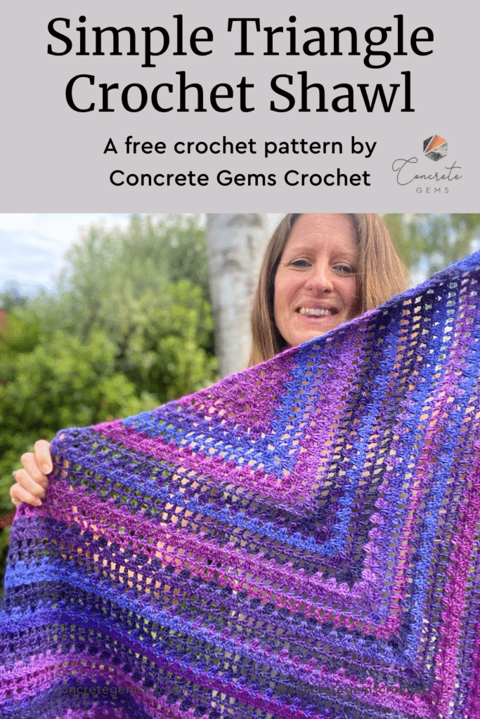 A pin image of a crochet triangle shawl being held up by a lady in a garden