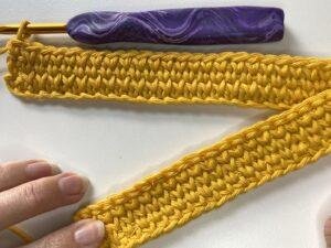 A small sample of crochet with a hook showcasing the waistcoat stitch