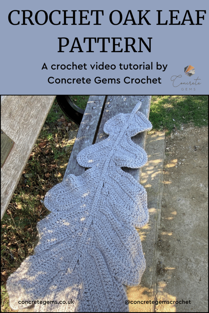 a leaf crochet blanket lies over a bench in a garden