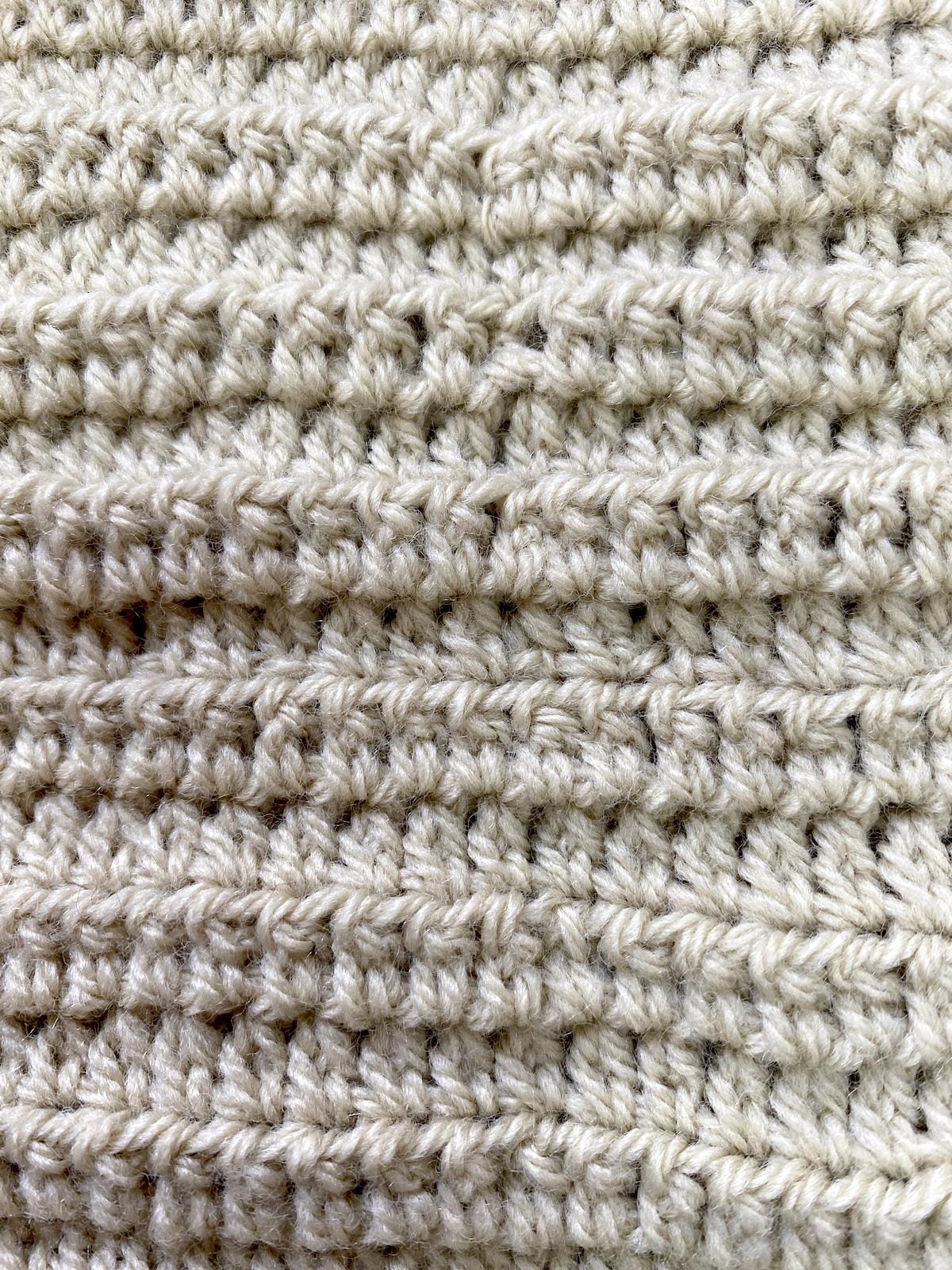A large fabric of extended half double crochet stitches in beige