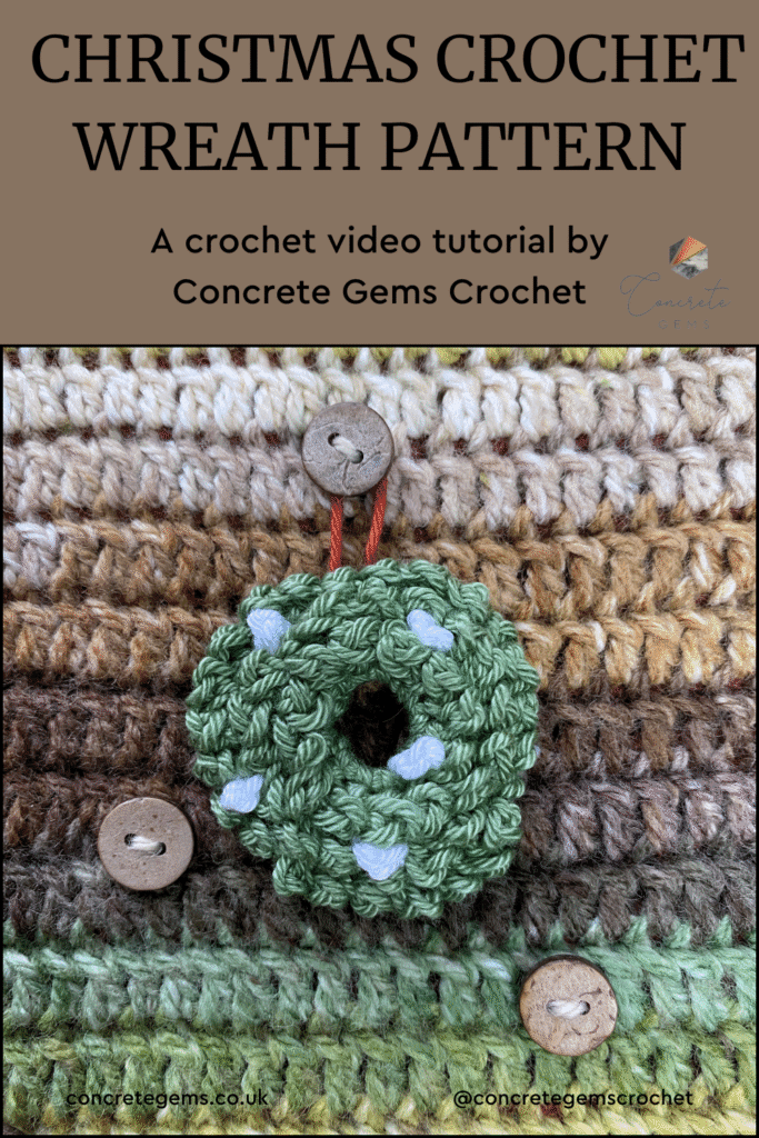 A mini crochet wreath with white berries on is hung on a green and brown crochet background. The words CHRISTMAS CROCHET WREATH PATTERN are above