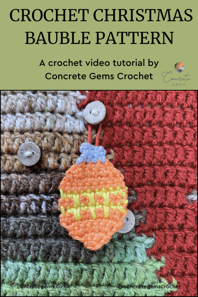 An orange crochet bauble with yellow zigzags hangs on a button on a crochet wall hanging and the words CROCHET CHRISTMAS BAUBLE PATTERN are above