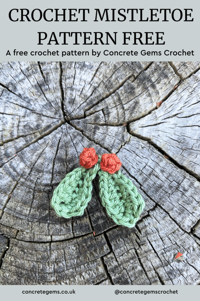 A pin image of a small crochet mistletoe decoration on a log