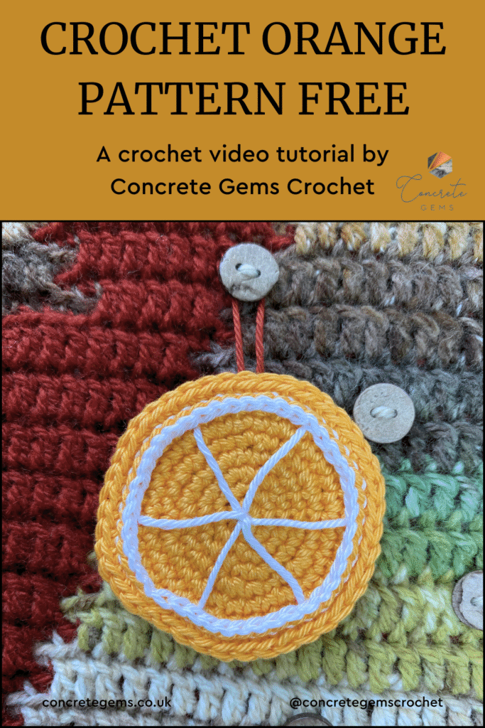 A crochet orange slice is hanging on a button on a crochet advent calendar with the words CROCHET ORANGE PATTERN FREE above