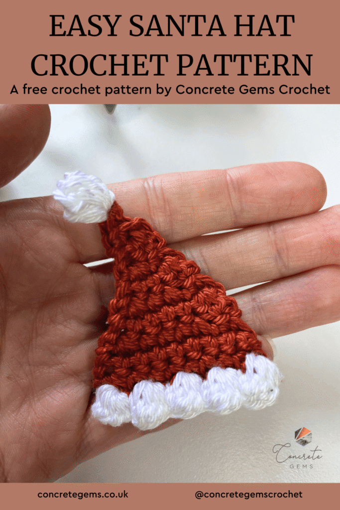 A tiny crochet Santa Hat lays in someones hand with the words EASY SANTA HAT CROCHET PATTERN above