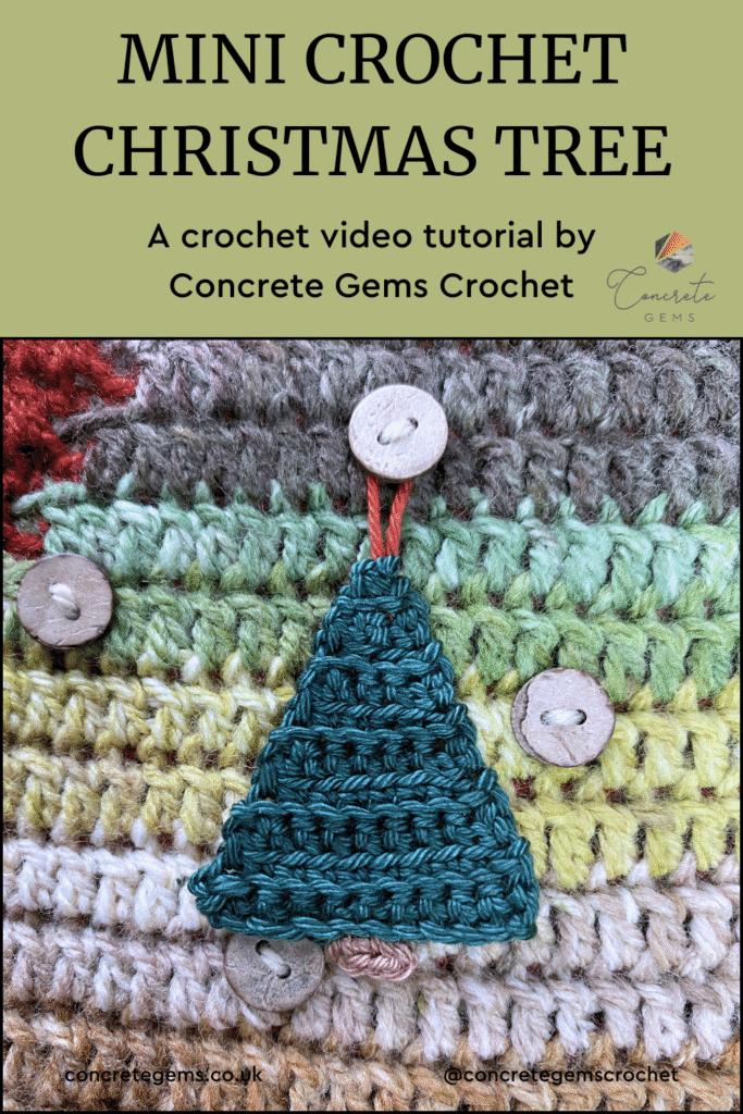 A mini crochet Christmas tree hangs from a button on a crochet advent calendar wall hanging