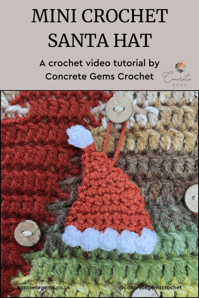 A tiny crochet Santa Hat hangs on a button on a crochet advent calendar and the words MINI CROCHET SANTA HAT above