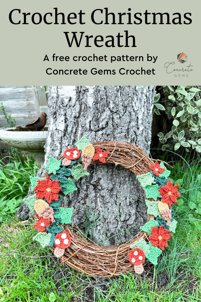 A crochet wreath propped up against a tree with grass around and the words CROCHET CHRISTMAS WREATH above.