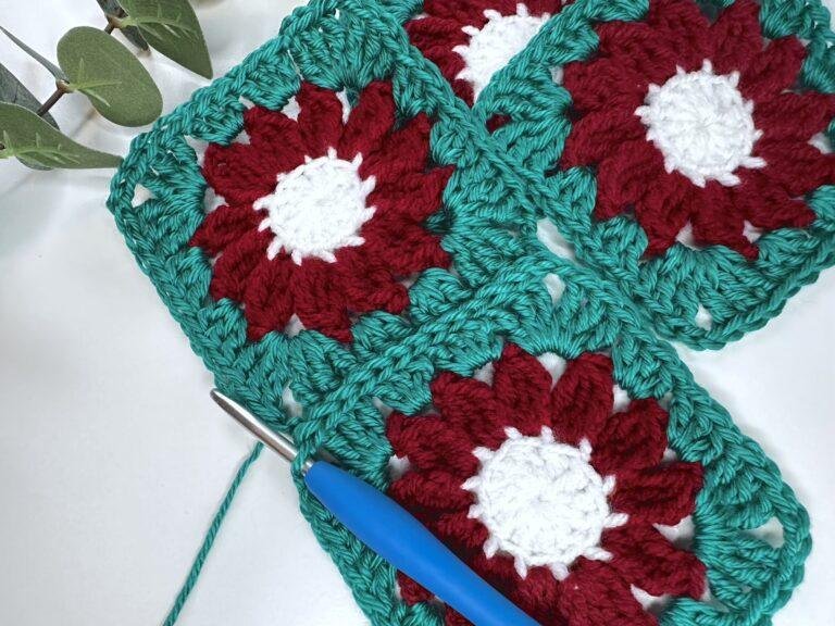 Two crochet granny squares have just been joined with a slip stitch seam in green and a further granny square is to the side.