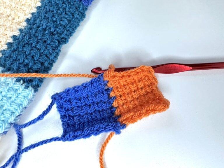 A sample of tunisian crochet entrelac showing a blue first square and a orange initial square next to a larger sample of entrelac
