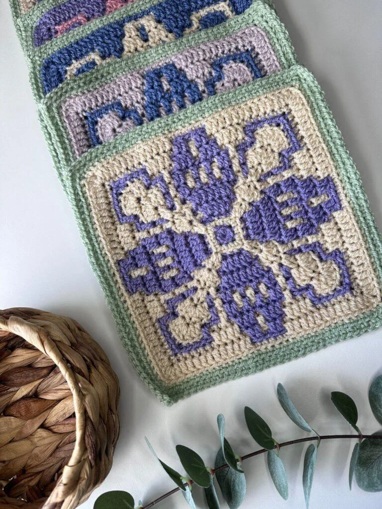 a pile of crochet mosaic squares with a flower motifs