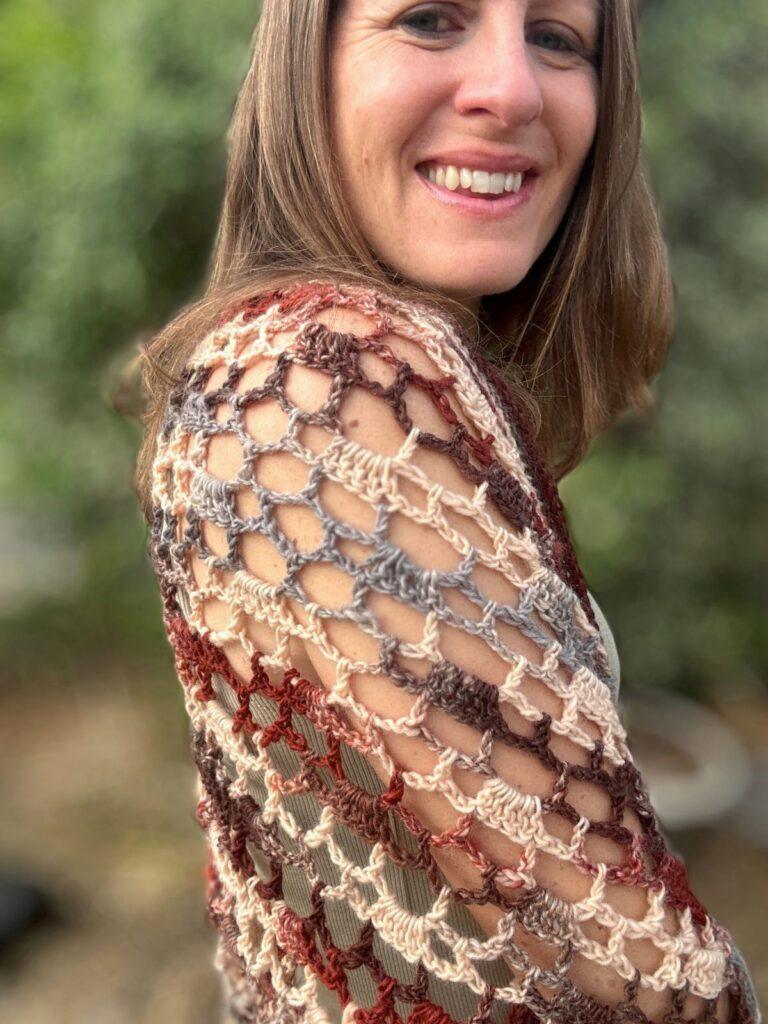 close up of the shoulder of the crochet cocoon cardigan showing the lacy stitch pattern