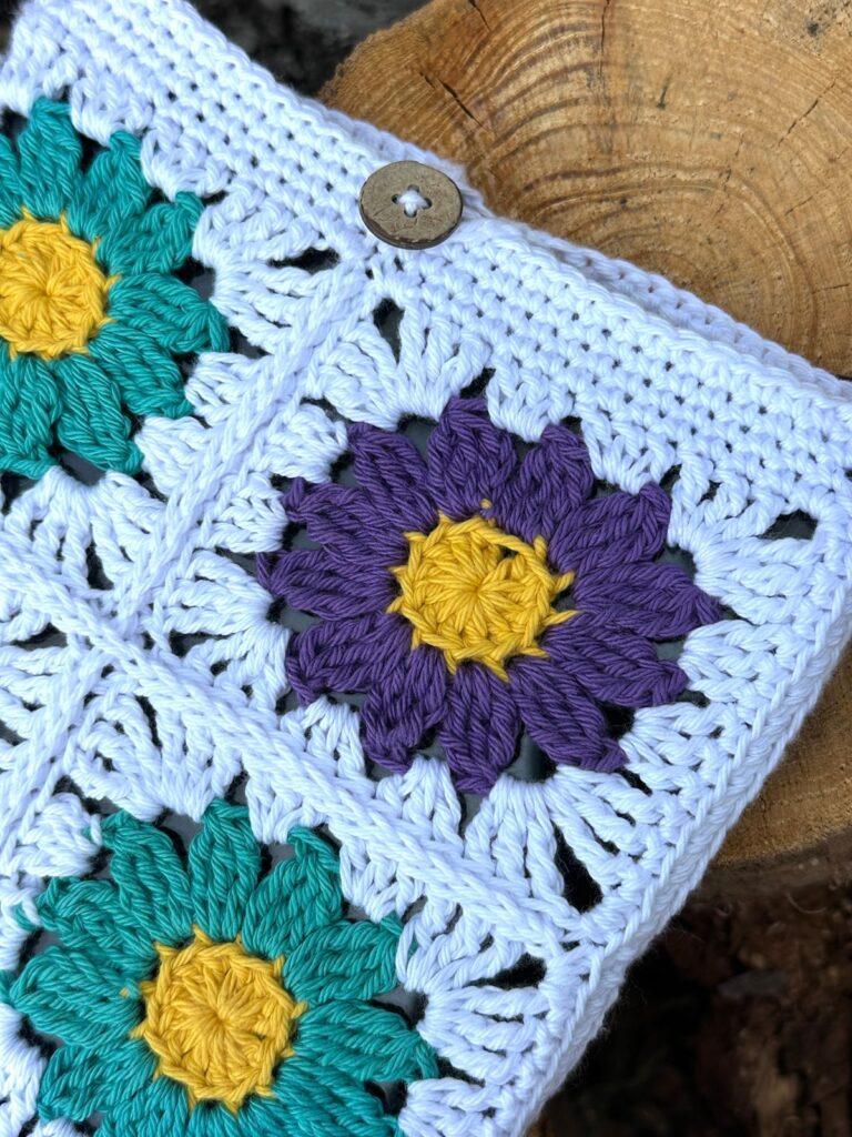 close up of a crochet granny square tablet cover with button fastening