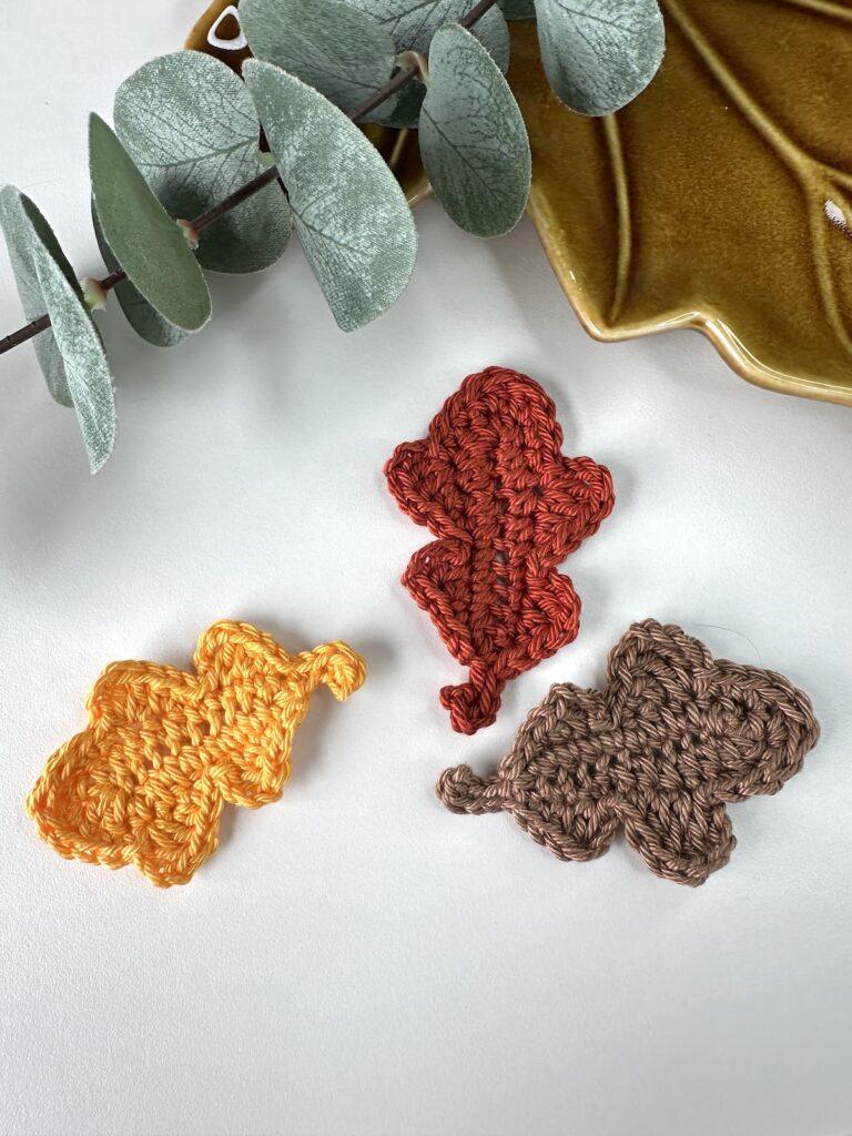 3 crochet oak leaves in orange, red and brown