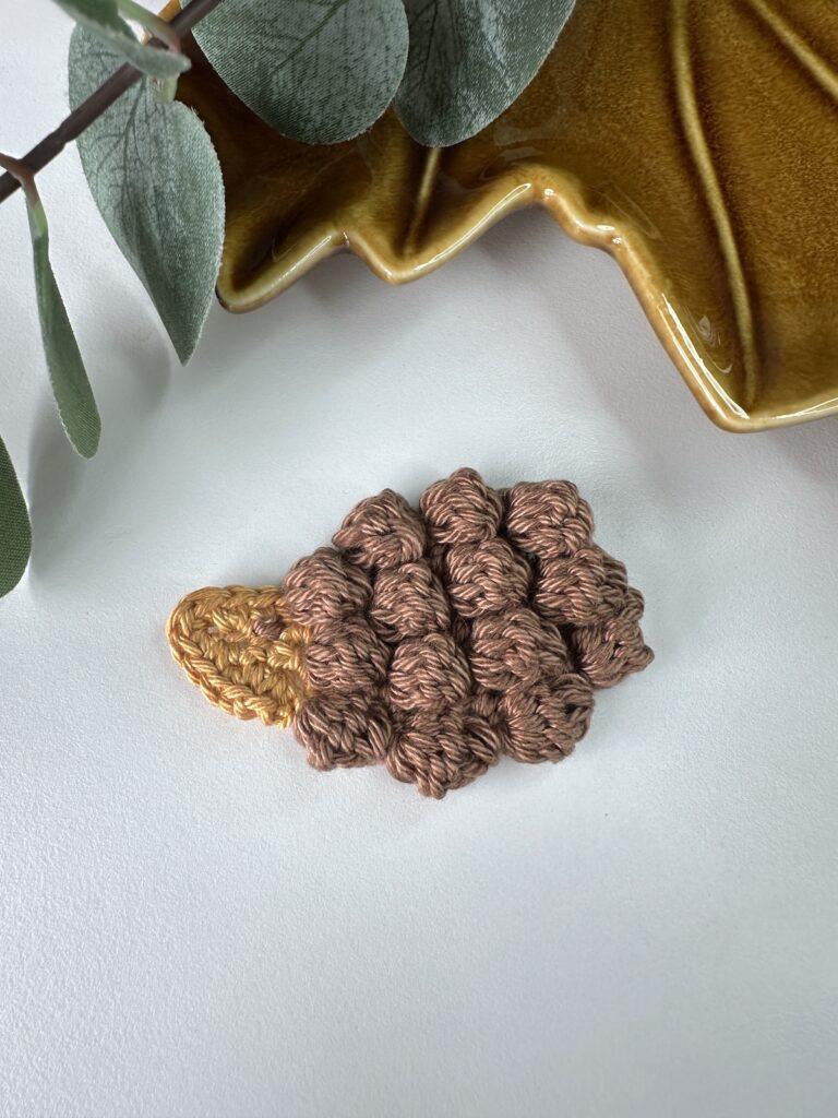 Crochet hedgehog applique with brown bobble stitch spines